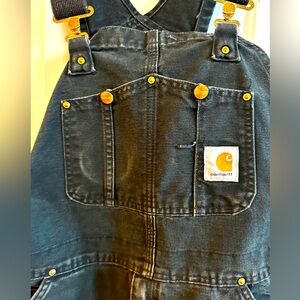 Well-worn Black Carhartt overalls 36x34. The bottom cuffs are in good shape